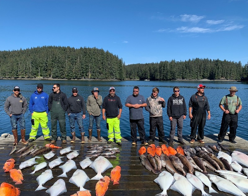 Alaskan Fishing Adventure: A large group of anglers standing on the dock after a day of fishing near Afognak Island, Alaska.