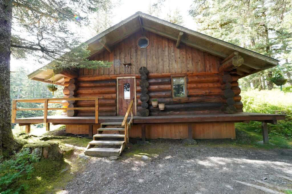 An exterior view of a rustic log cabin on Afognak Island, Alaska.