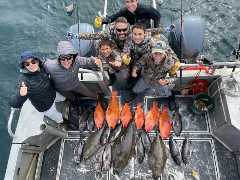 Fishing Terms: A group of anglers smiling with a large haul of Alaskan fish.